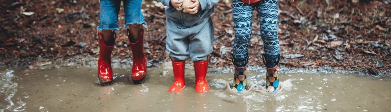 Enfants qui jouent dans la pluie pour s'occuper quand il ne fait pas beau au Luxembourg