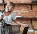 Une femme dans un bureau moderne, se préparant à quitter son poste, reflétant la gestion efficace des congés en 2025